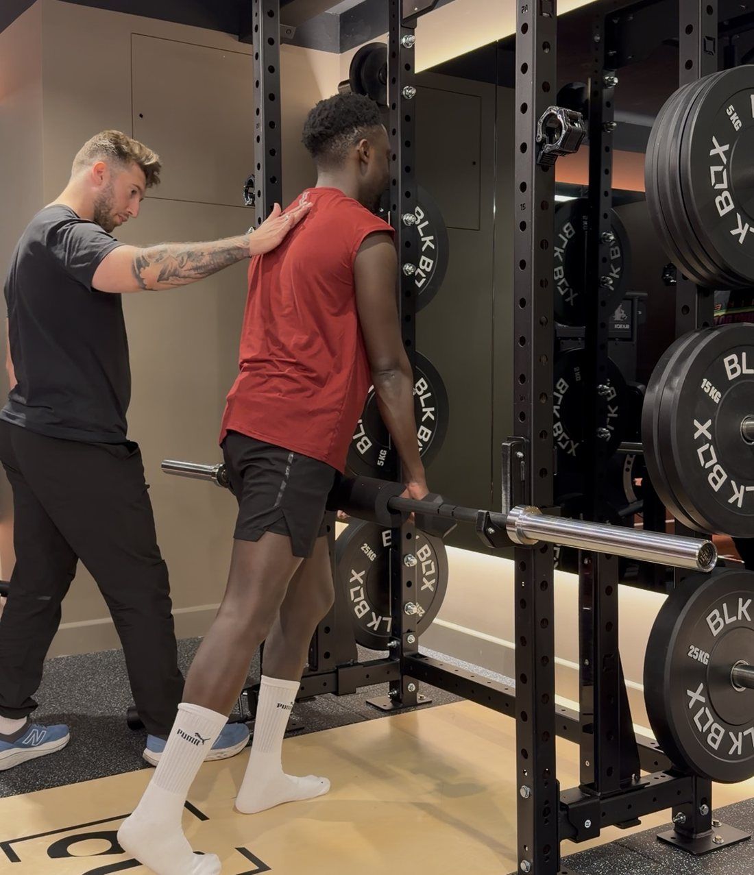 Giacomo Di Mauro coaching a client at the rack