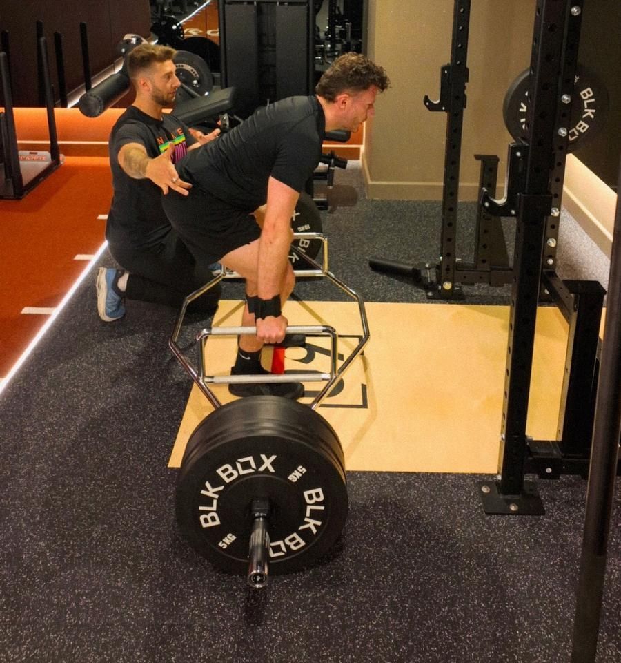 Client performing trap bar deadlift assessment at FORMA